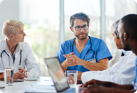 A group of clinicians sitting at a table talking